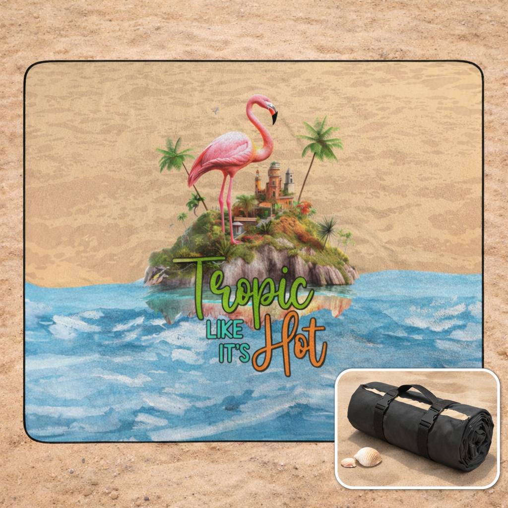 Outside beach blanket with a tropical design featuring a flamingo and palm trees, with it rolled as a small black bag inset.