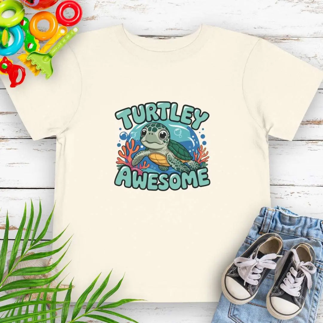 Turtley Awesome Toddler's Natural T-shirt with cartoon sea turtle underwater.