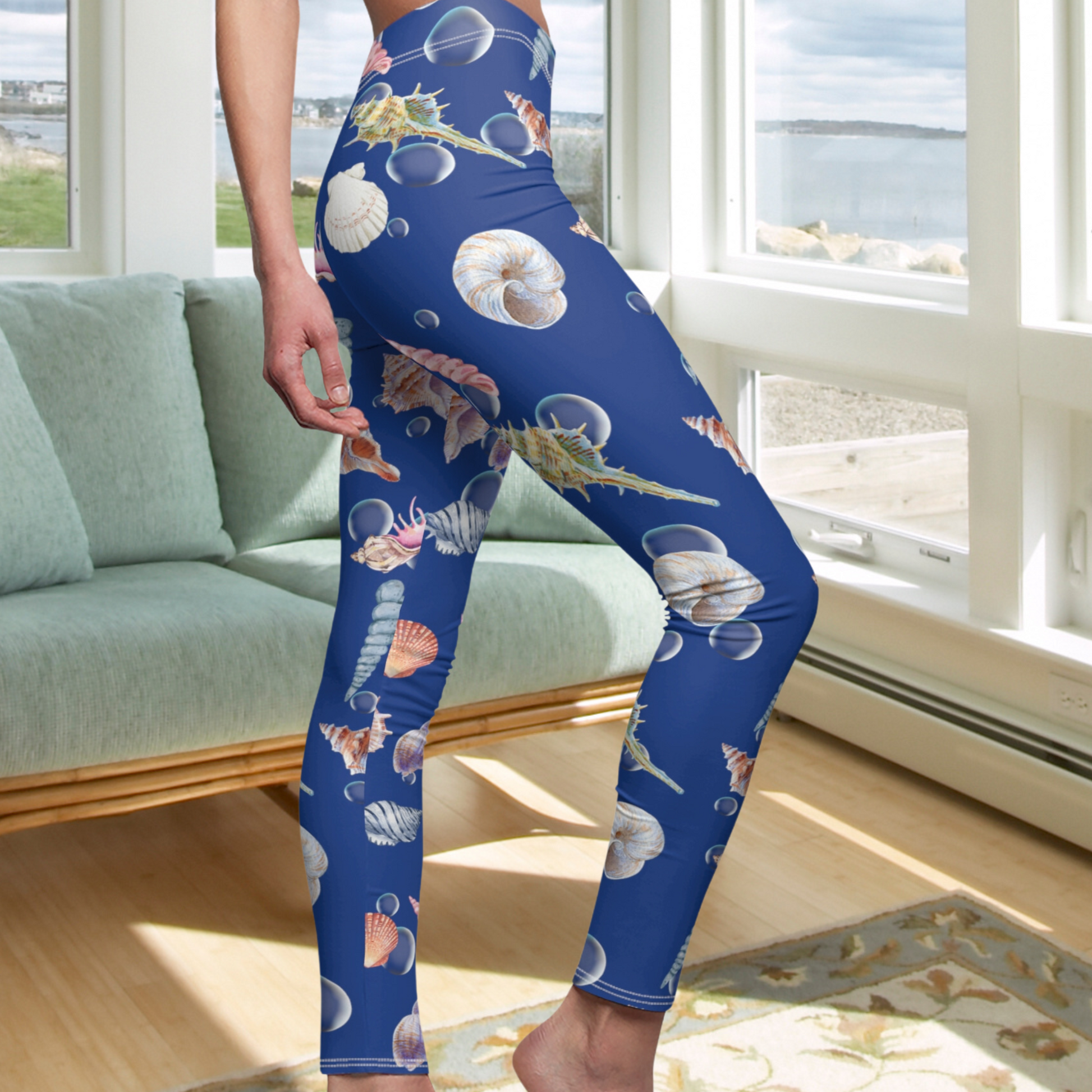 Side view of Blue leggings with seashells and ocean water bubbles.