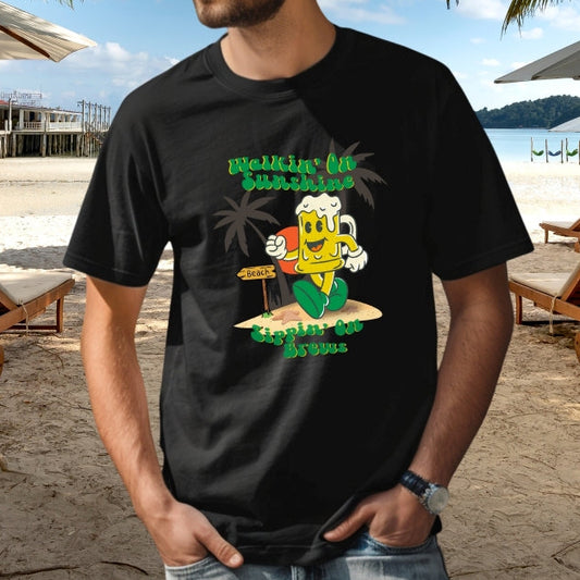 Man wearing black T-shirt with cartoon beer walking on the beach with the text Walkin' On Sunshine Sippin' on Brews. 