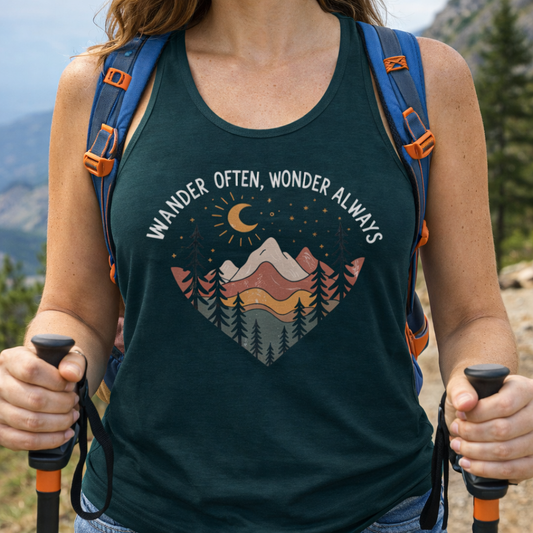 Person wearing a tank top with a nature-themed heart design with text Wander Often, Wonder Always.