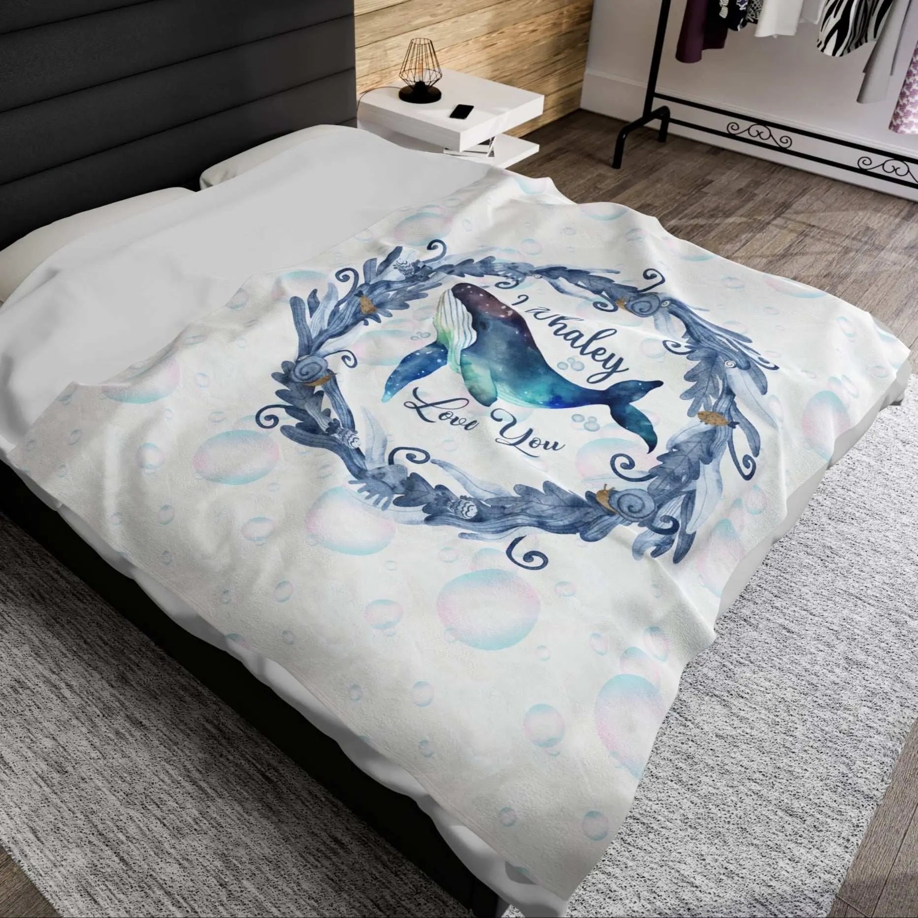 White Velveteen Plush blanket with blue marine plant wreath with swimming whale in the middle and text I Whaley Love You -perfect for snuggling up with your beachy loved ones!