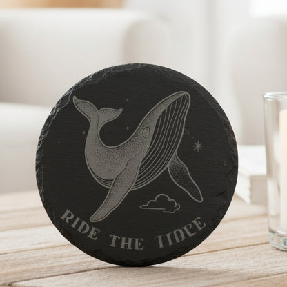 Black engraved slate coaster with whale and text Ride the Tide.