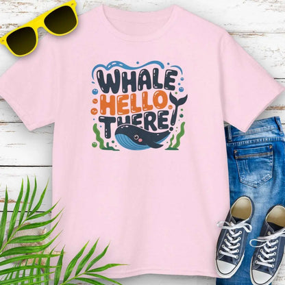Whale Hello Child's Pink T-Shirt with a fun whale swimming under the text with water bubbles and seaweed.