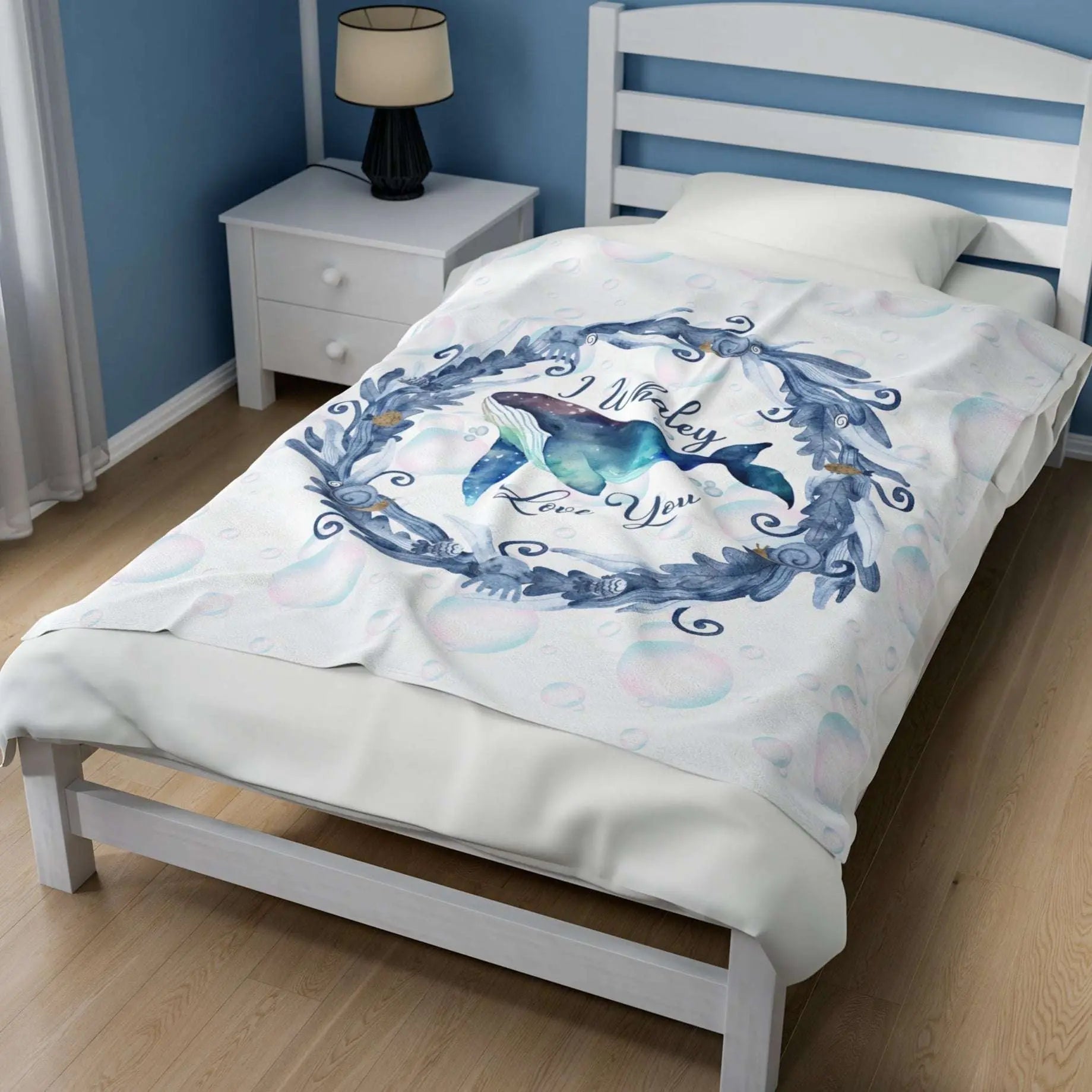 White Velveteen Plush blanket with blue marine plant wreath with swimming whale in the middle and text I Whaley Love You -perfect for snuggling up with your beachy loved ones!