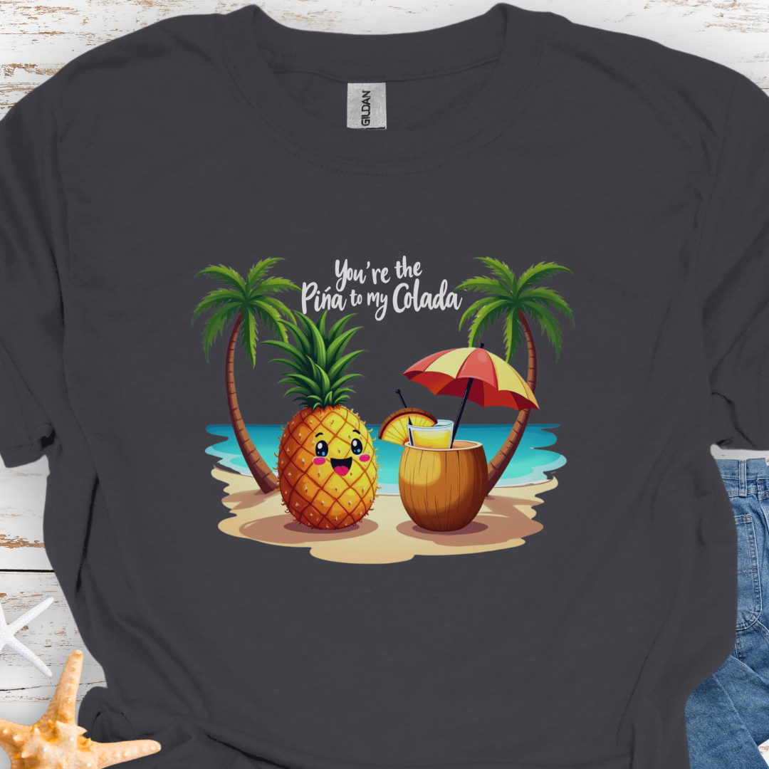 Charcoal T-shirt with a pineapple and a coconut pina colada on a beach between two palm trees with the text You're the Pina to my Colada.