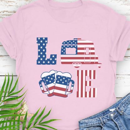 Light Pink T-shirt with patriotic LOVE design: blue star-patterned L, American flag camper as O, beer mugs forming V, and red-striped E – playful 4th of July theme.
