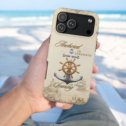 Phone case with anchor design and text held by a person on a beach.