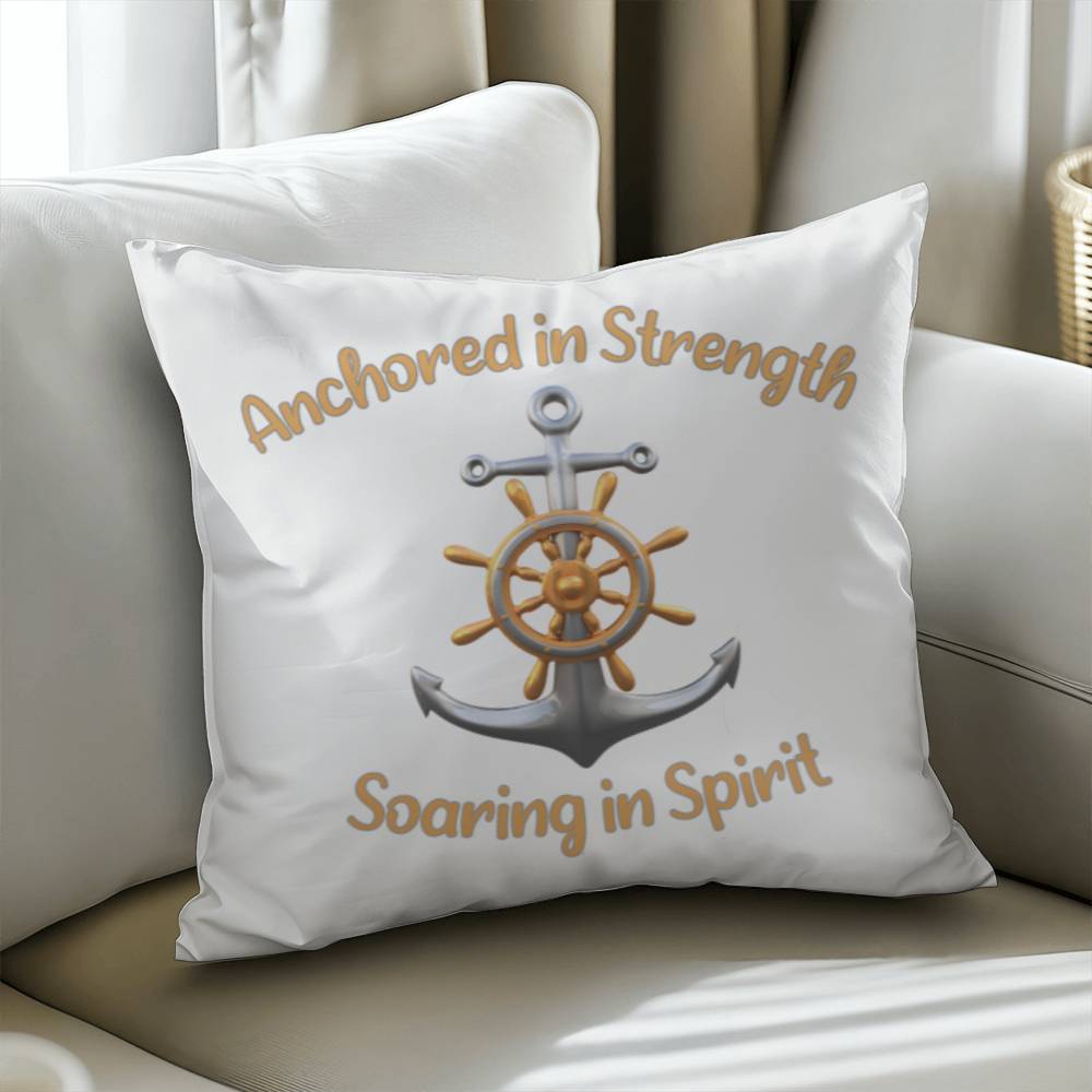 White pillow with a picture of an anchor and the words Anchored in Strength Soaring in Spirt surrounding sitting on a couch