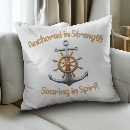 White pillow with a picture of an anchor and the words Anchored in Strength Soaring in Spirt surrounding sitting on a couch