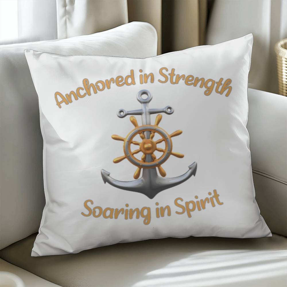 White pillow with a picture of an anchor and the words Anchored in Strength Soaring in Spirt surrounding sitting on a couch