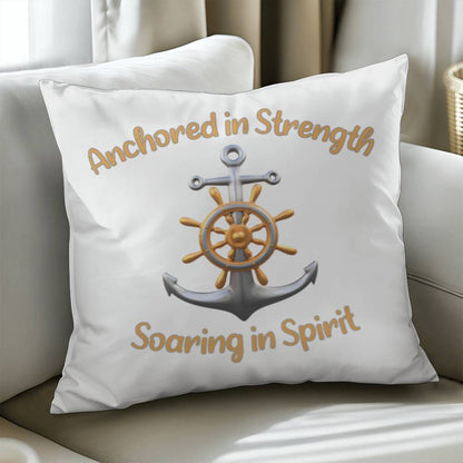 White pillow with a picture of an anchor and the words Anchored in Strength Soaring in Spirt surrounding sitting on a couch