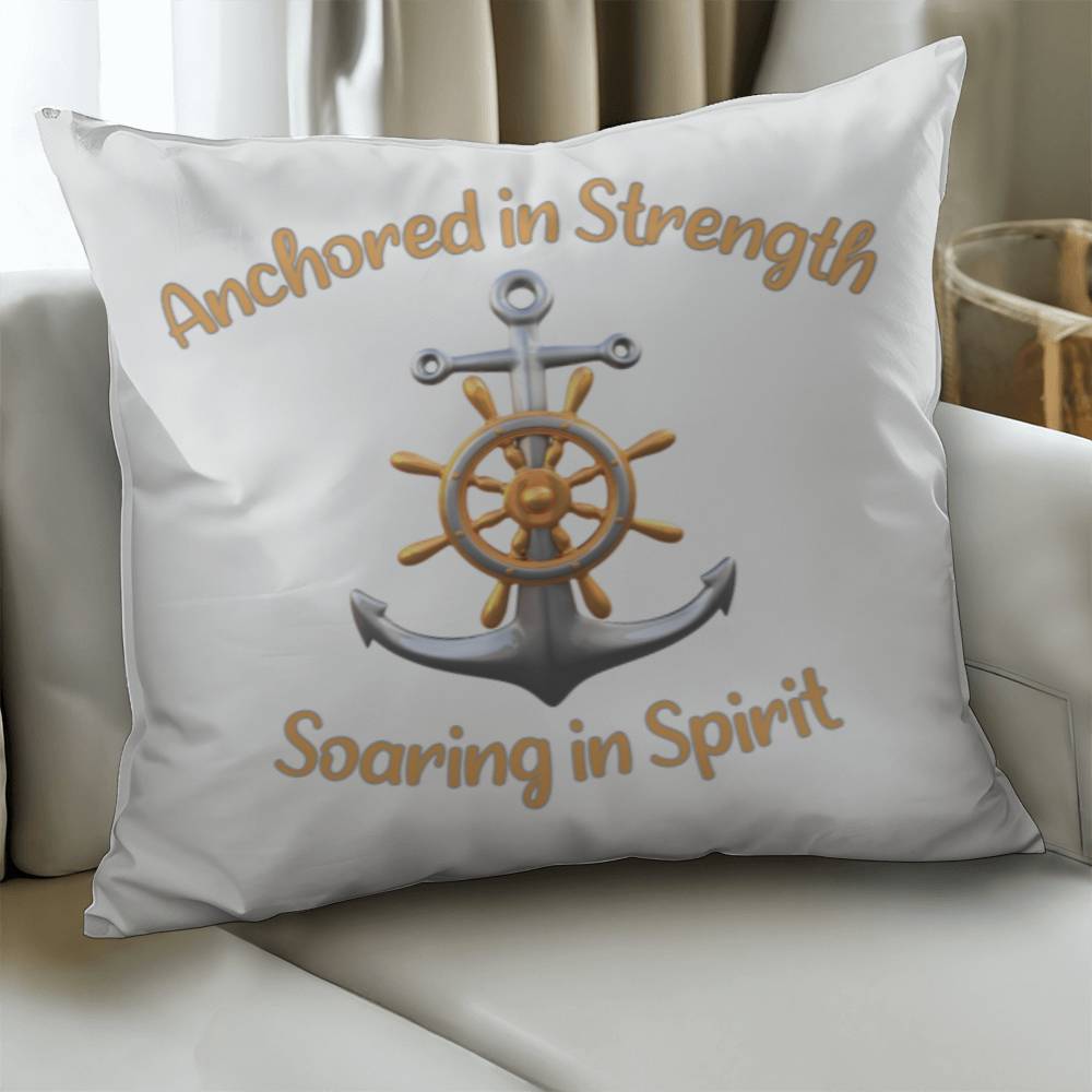 White pillow with a picture of an anchor and the words Anchored in Strength Soaring in Spirt surrounding sitting on a couch