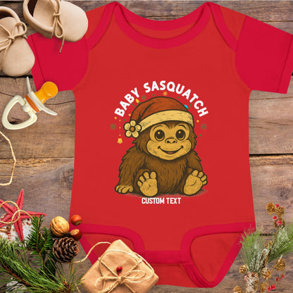 Red baby onesie with 'Baby Sasquatch' design with custom text.