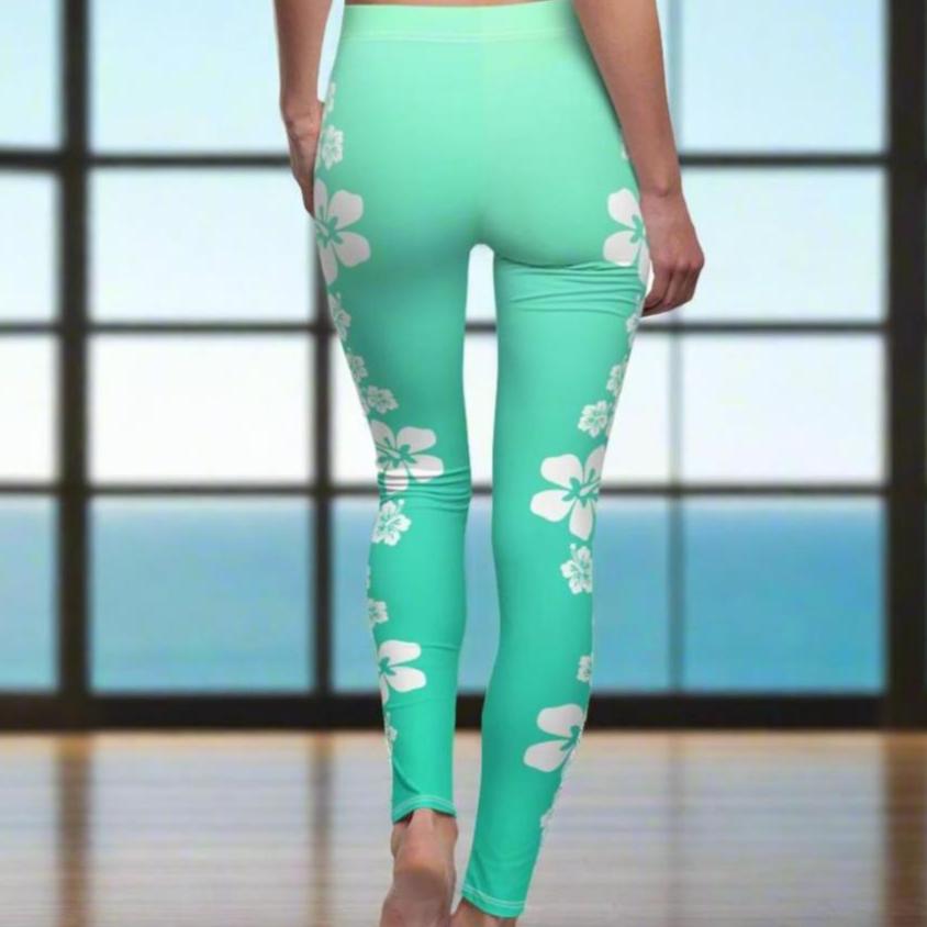 Back of aqua colored leggings with white hibiscus flowers