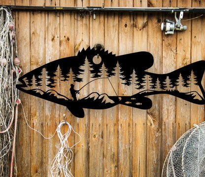 Black  intricate metal art sign featuring a bass fish with a man fishing inside the fish. A unique and detailed design, perfect for fishing enthusiasts and rustic home or cabin decor.