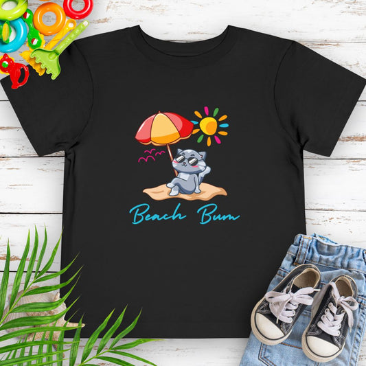 Black Beach Bum toddler t-shirt with vibrant playful summer design of a cute cat wearing sunglasses laying on the beach under an umbrella. 