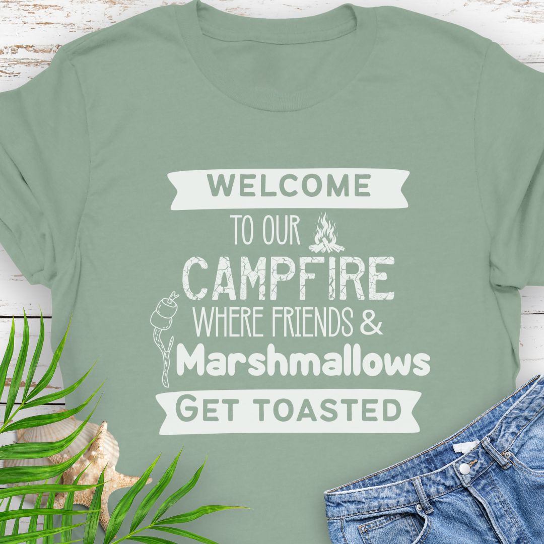 Sage Green Funny “Welcome to Our Campfire Where Friends & Marshmallows Get Toasted” t-shirt with bold text design for campers and party lovers