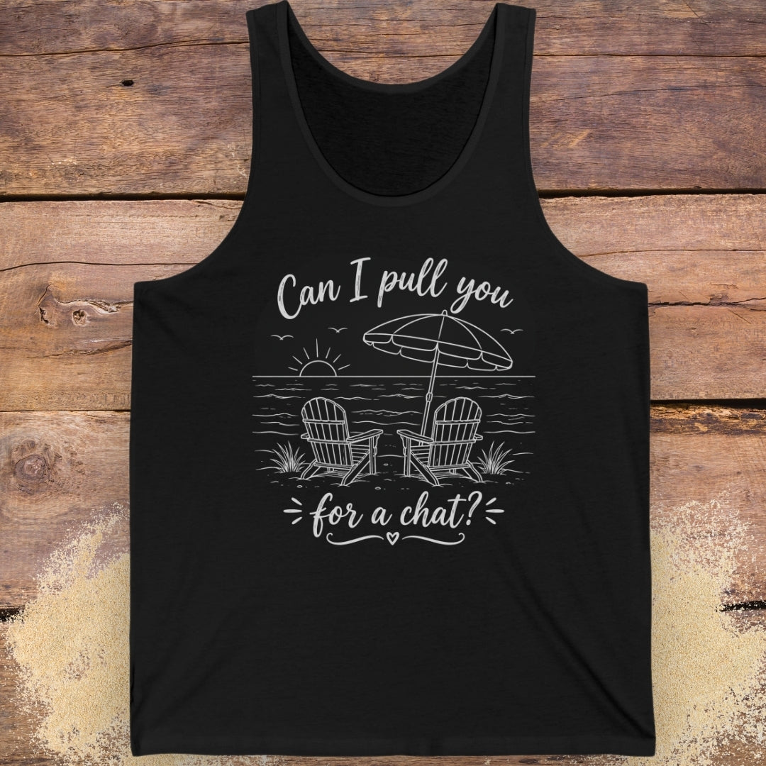 Black tank top with beach graphic and text  "Can I pull you for a chat?" on a wooden surface.