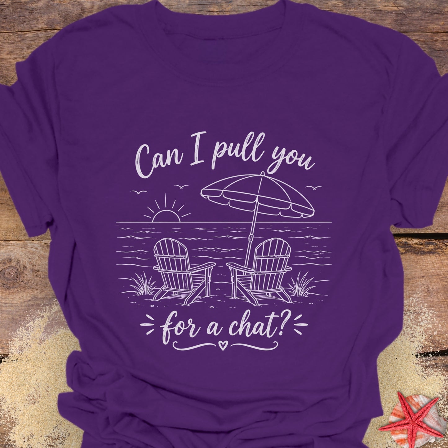 Purple t-shirt with a beach graphic and text "Can I pull you for a chat?".