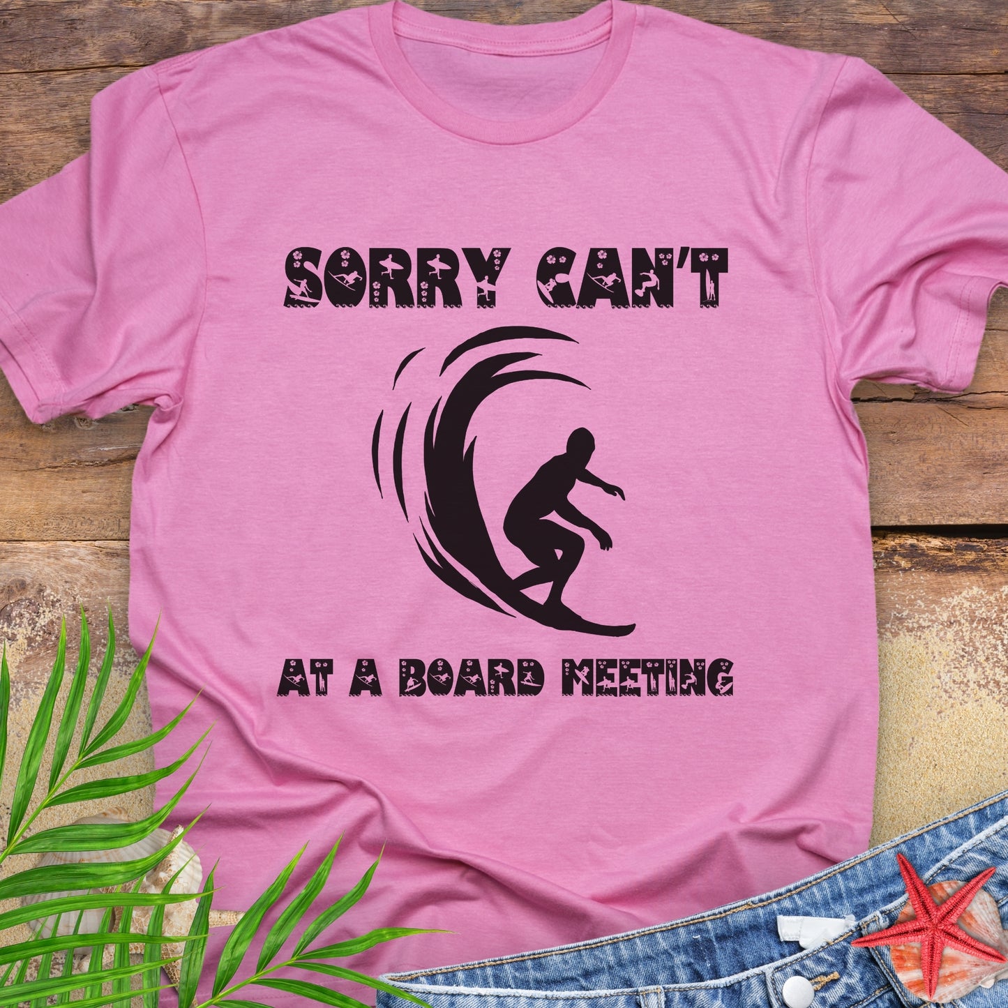 Pink t-shirt with a surfer and says Sorry Can't Board Meeting.