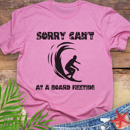 Pink t-shirt with a surfer and says Sorry Can't Board Meeting.