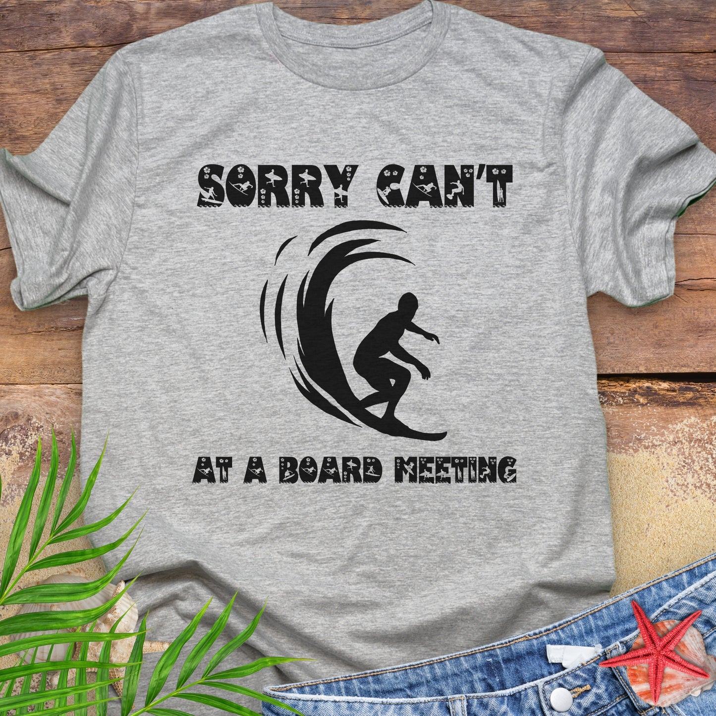 Gray t-shirt with a surfer and says Sorry Can't Board Meeting.