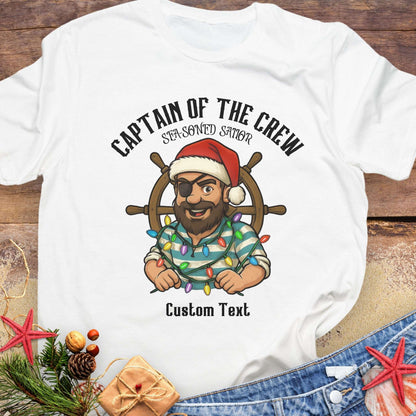 White t-shirt with a pirate graphic and text 'Captain of the Crew Sea-soned Sailor' with Christmas decorations that can be personalized.