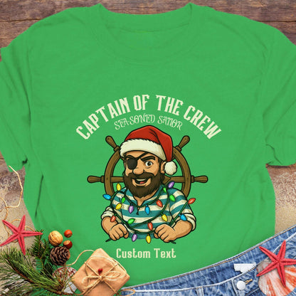 Green t-shirt with a pirate graphic and text 'Captain of the Crew Sea-soned Sailor' with Christmas decorations that can be personalized.