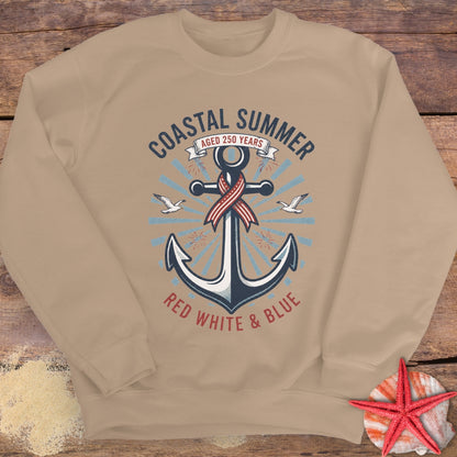 Beige sweatshirt with an anchor design and 'Coastal Summer' text on a wooden surface.