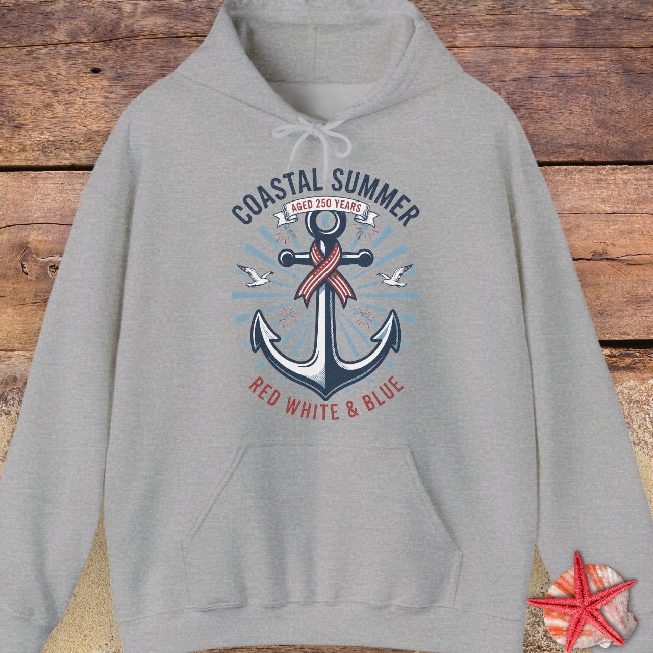 Gray hoodie with an anchor design on a wooden surface