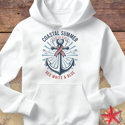 White hoodie with an anchor design and text on a wooden surface