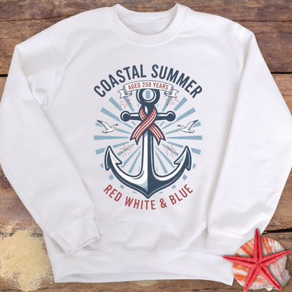 White sweatshirt with anchor design and 'Coastal Summer' text on a wooden surface.
