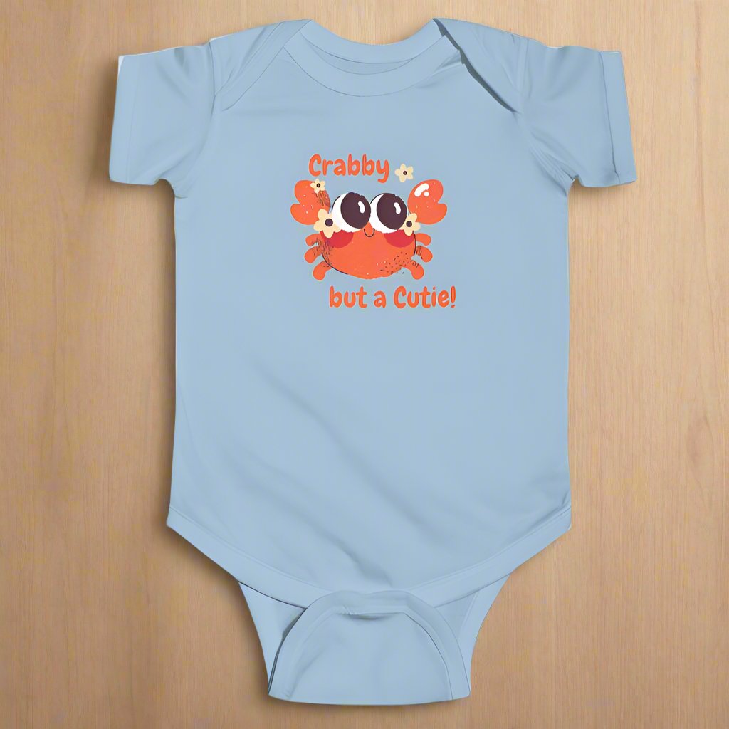 Baby Blue short sleeved body suit with cartoon crab that says crabby but a cutie