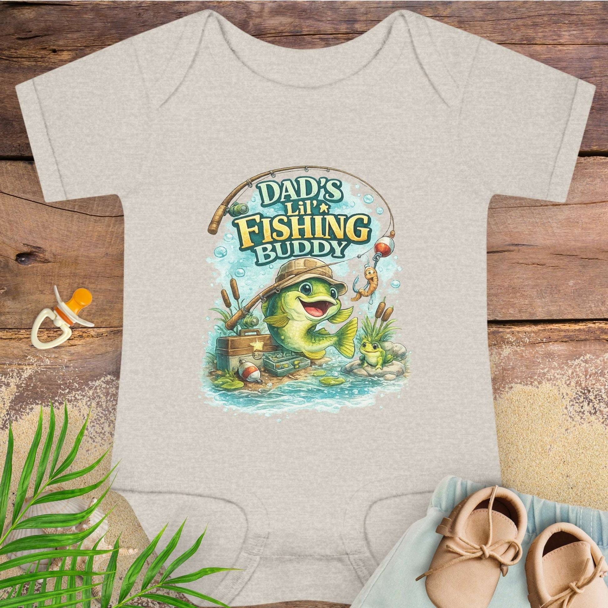 Beige baby onesie with 'Dad's Lil' Fishing Buddy' design.