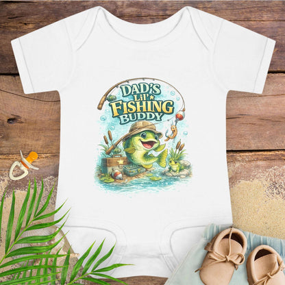 White baby onesie with 'Dad's Lil' Fishing Buddy' design.