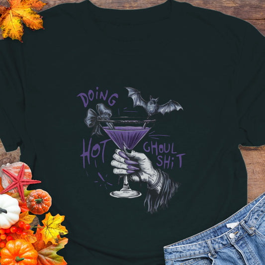 Black t-shirt with Halloween-themed design featuring a hand holding a martini glass with a bat and text.
