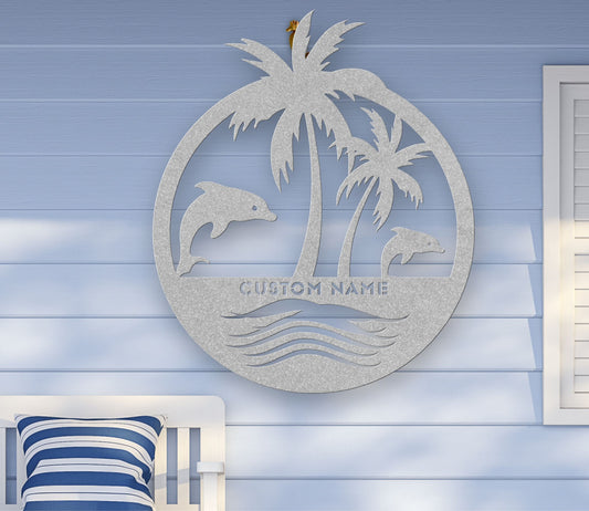Silver custom metal wall art featuring two dolphins jumping near palm trees with space for a family name, established year, or custom phrase in various sizes.