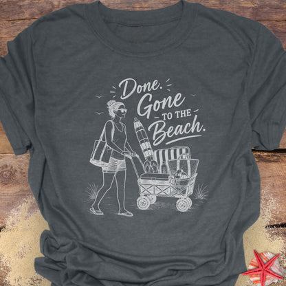 Dark Heather Gray unisex t-shirt with a woman pushing a cart of beach equipment and text "Done. Gone to the Beach."