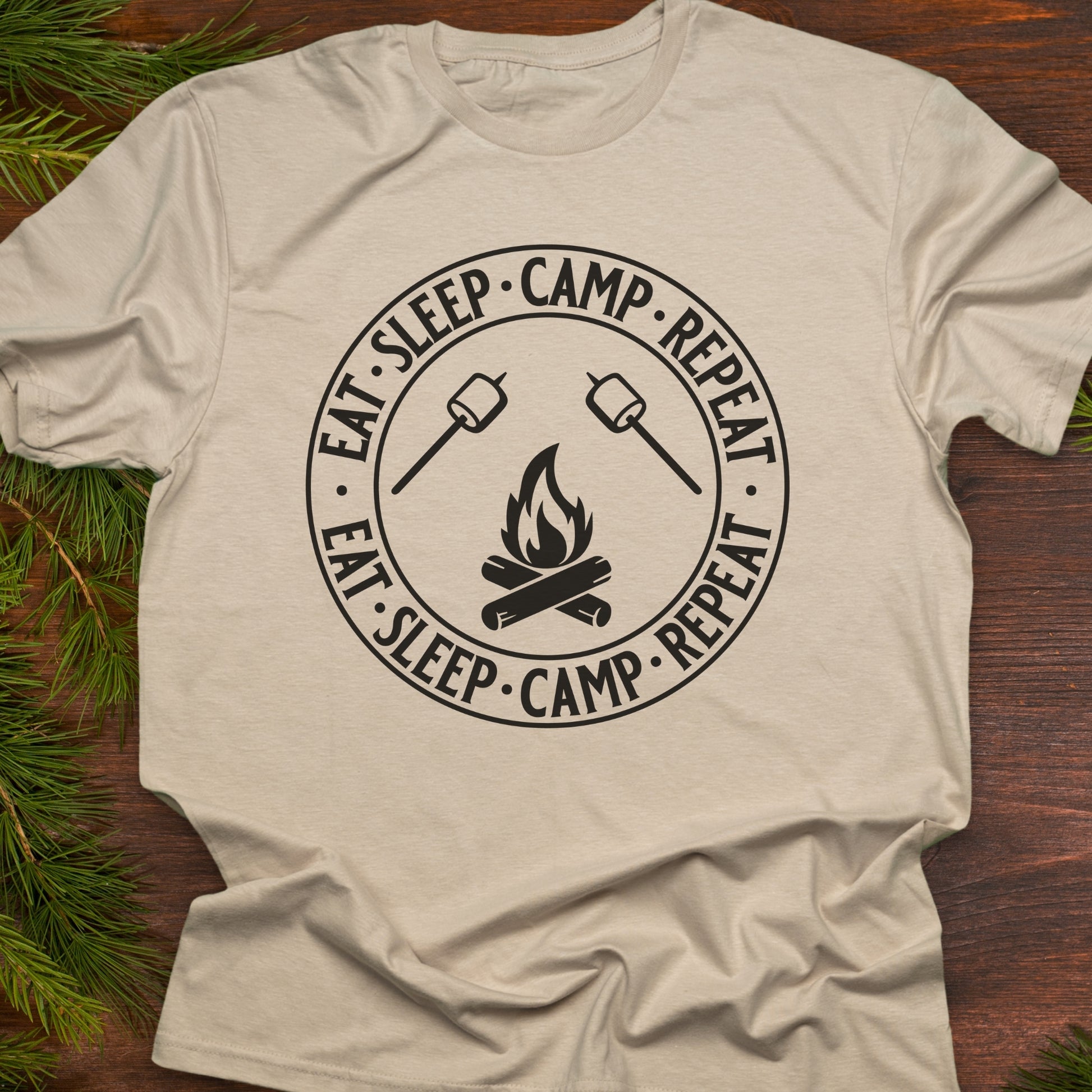 Beige  t-shirt with 'Eat Sleep Camp Repeat' graphic.