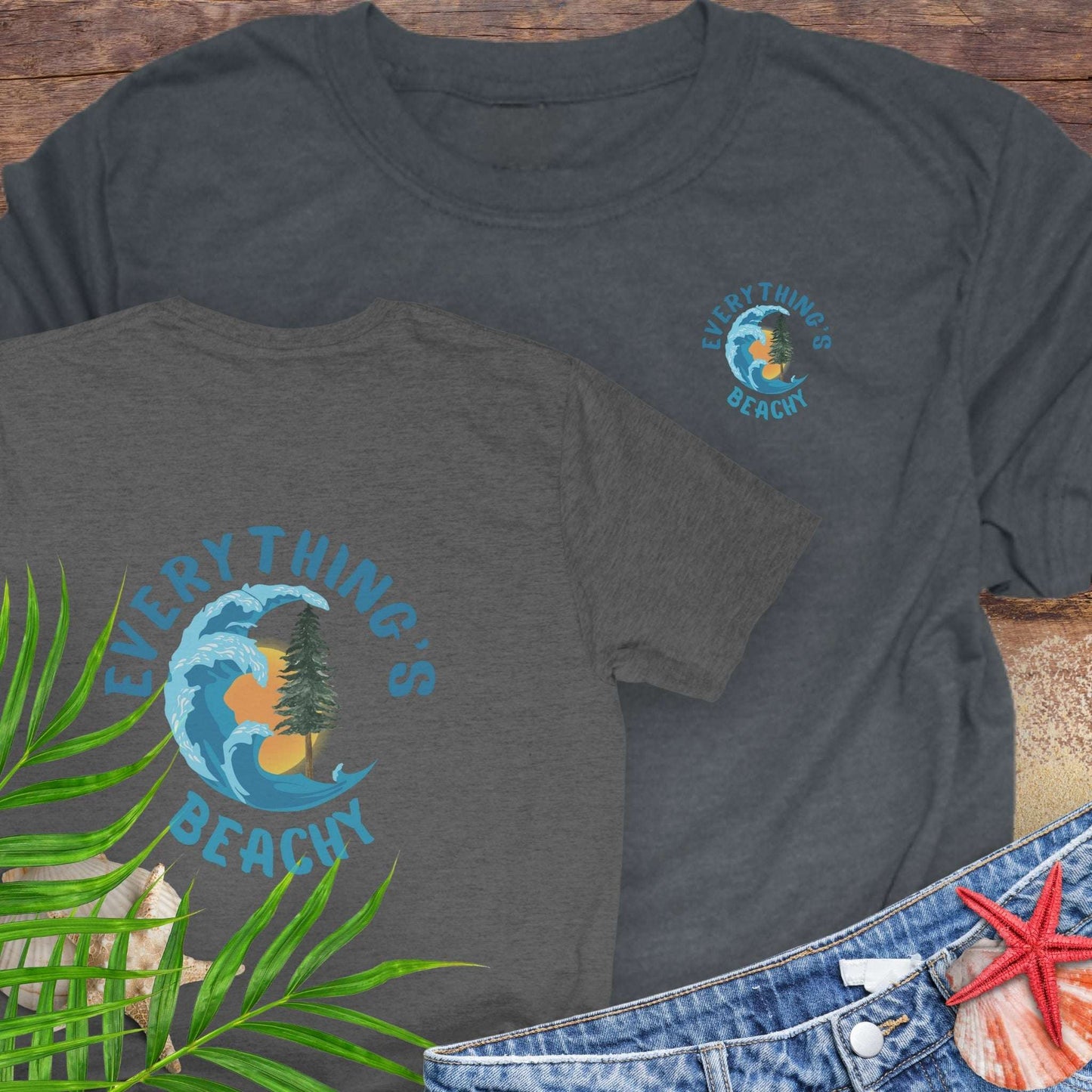 Two dark gray t-shirts with Everything’s Beachy logo with wave, sun, and redwood graphic front and back.