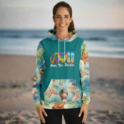 Woman in sweatshirt with teal front and back with seashell patterned sleeves, kangaroo pouch and hood with peace love flip flops.