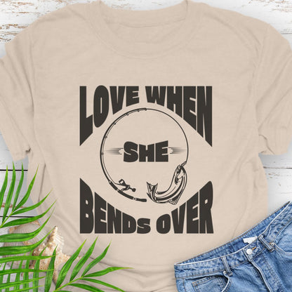 Natural T-shirt with a fishing pole bending over and the phrase “Love When She Bends Over” – humorous fishing design for anglers