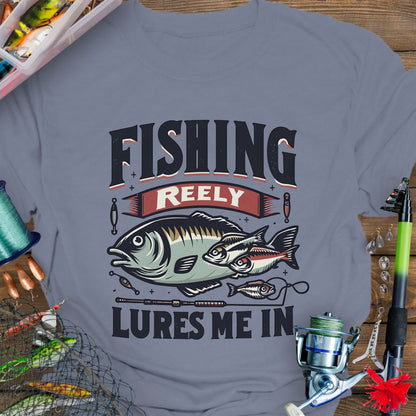 Indigo Bllue Unisex T-shirt featuring the phrase 'Fishing Reely Lures Me In' with a detailed graphic of a fish and fishing lures. Perfect for anglers and fishing enthusiasts, this comfortable tee is great for casual wear, fishing trips, and outdoor adventures.