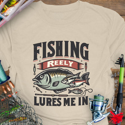 Natural Unisex T-shirt featuring the phrase 'Fishing Reely Lures Me In' with a detailed graphic of a fish and fishing lures. Perfect for anglers and fishing enthusiasts, this comfortable tee is great for casual wear, fishing trips, and outdoor adventures.