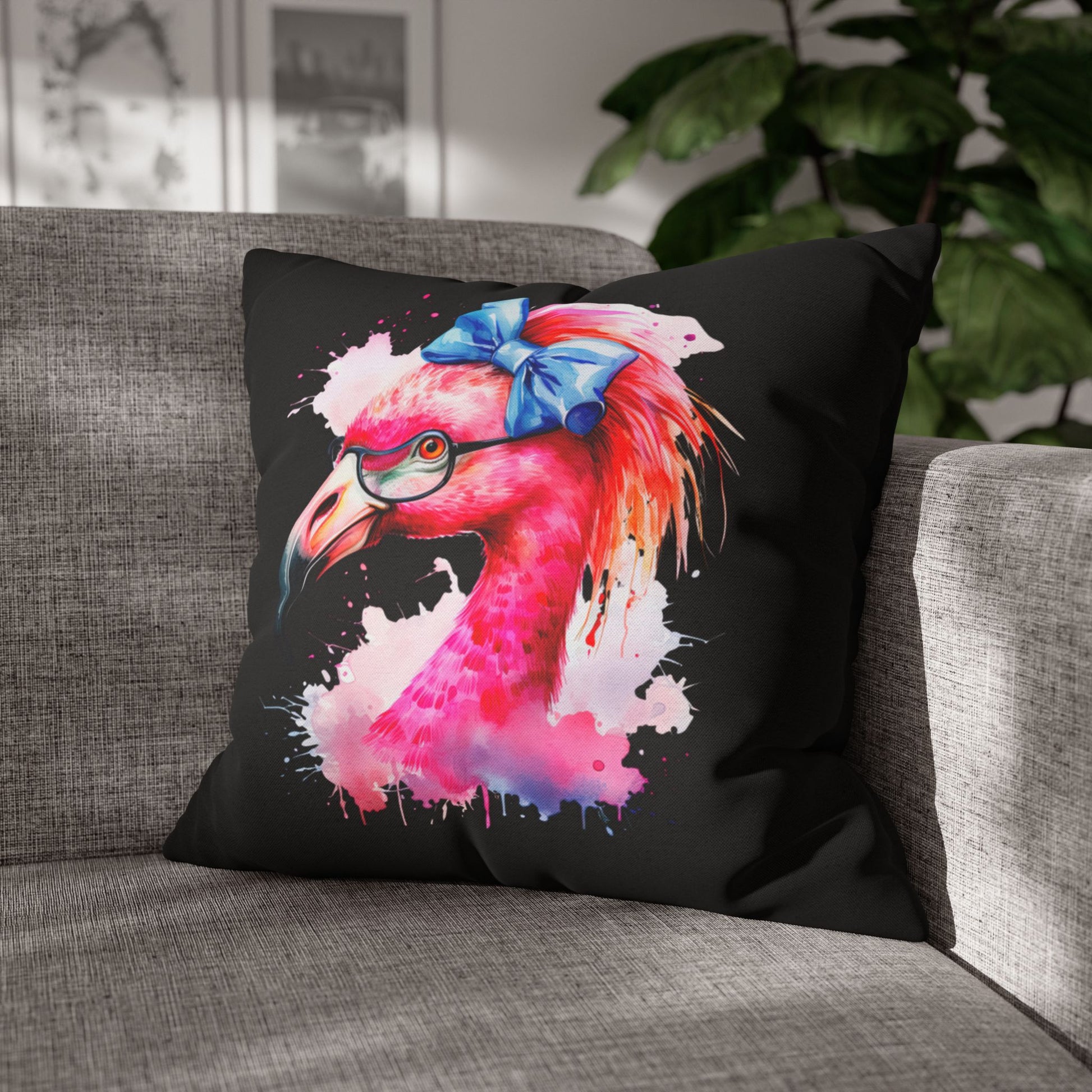 Decorative square pillowcase featuring a flamingo head wearing glasses and a big blue bow on a black background.