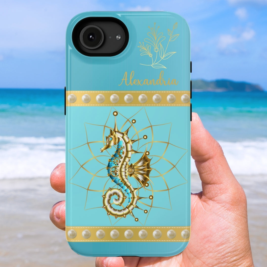 Phone case with seahorse design held by a hand on a beach