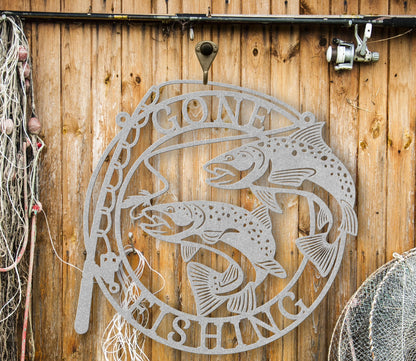 Silver Metal wall art featuring the phrase “Gone Fishing” with a fishing rod and fish silhouette, crafted from steel and available in multiple sizes and finishes.