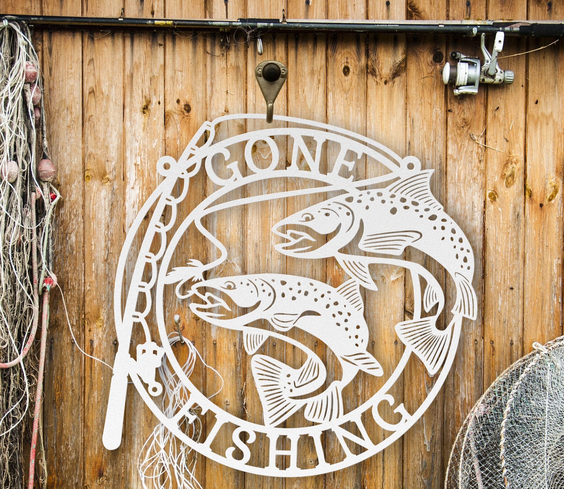 White Metal wall art featuring the phrase “Gone Fishing” with a fishing rod and fish silhouette, crafted from steel and available in multiple sizes and finishes.