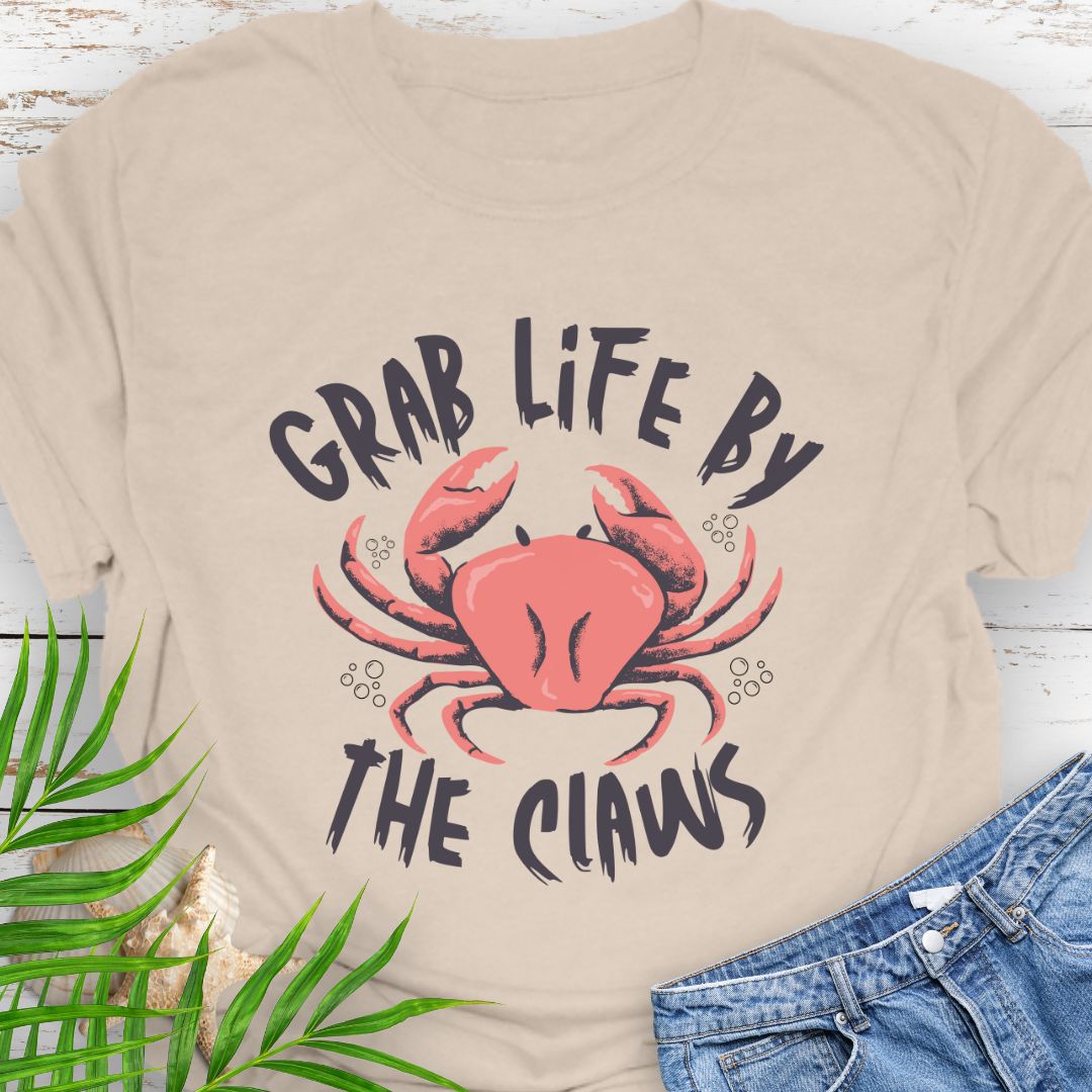Natural Unisex t-shirt with 'Grab Life by the Claws' crab graphic on front – coastal-themed summer apparel